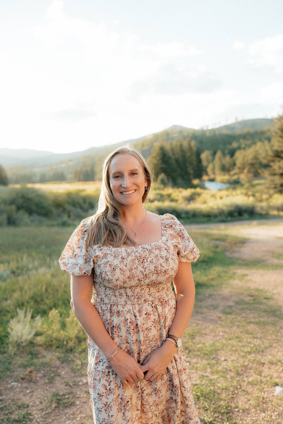 Ellen LeBleu smiling outdoors in a Colorado meadow